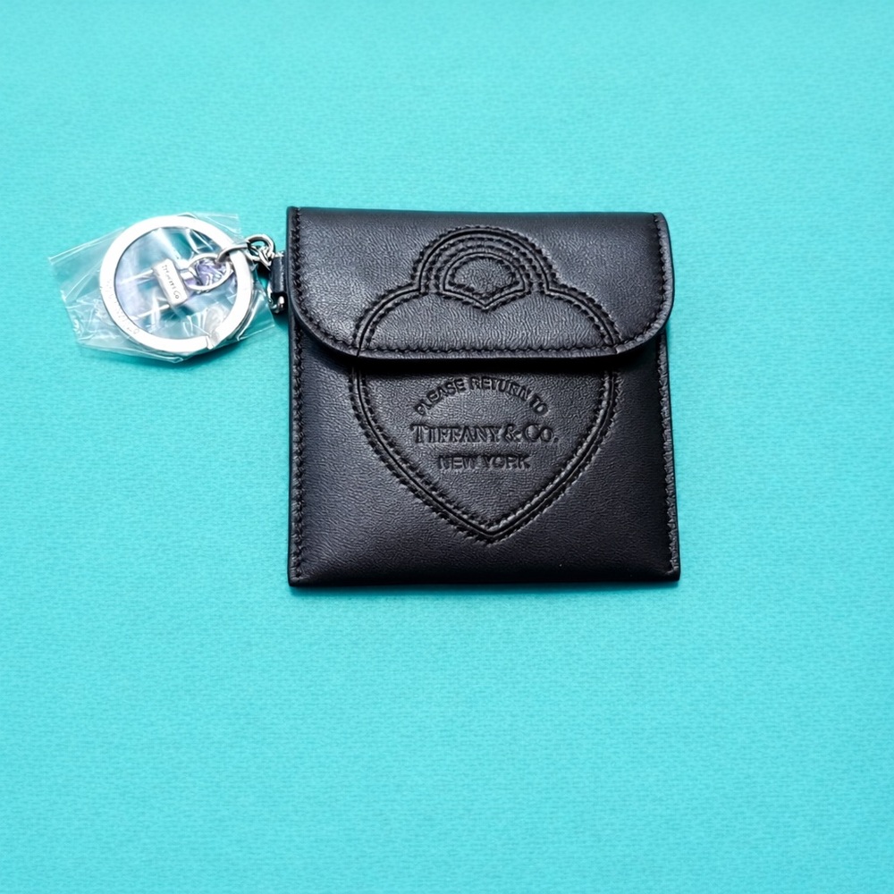 Tiffany & Co.Pouch Bag Charm in black leather and palladium-plated hardware.